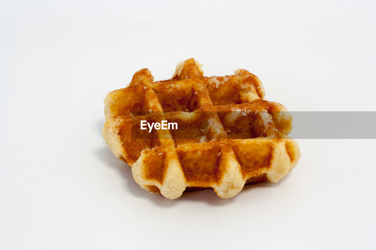 Close-up of waffle against white background