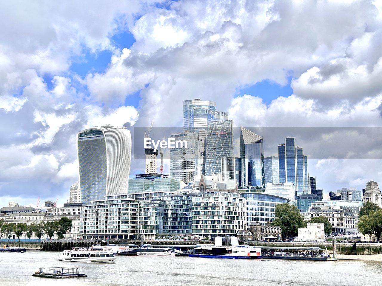 architecture, built structure, city, building exterior, building, sky, skyline, office building exterior, landscape, cityscape, cloud, skyscraper, urban skyline, water, landmark, travel destinations, ship, nature, residential district, office, transportation, travel, tower block, downtown district, downtown, urban area, nautical vessel, outdoors, day, no people, waterfront, city life, business, mode of transportation, harbor, tourism, vehicle, business finance and industry, river