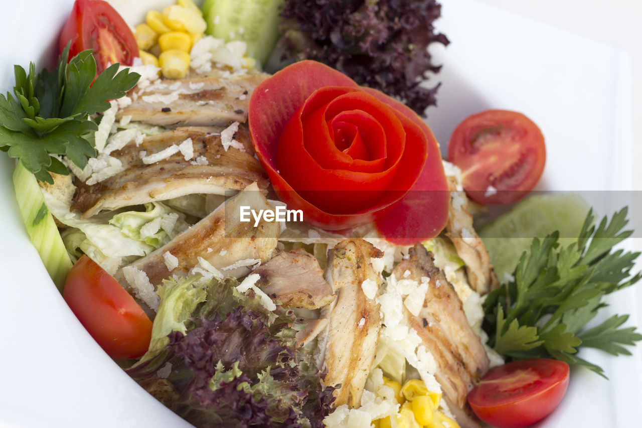 Close-up of rose shaped tomato on dish