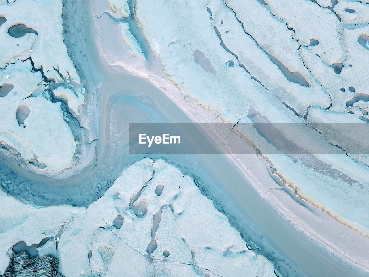 HIGH ANGLE VIEW OF FROZEN WATER ON LANDSCAPE