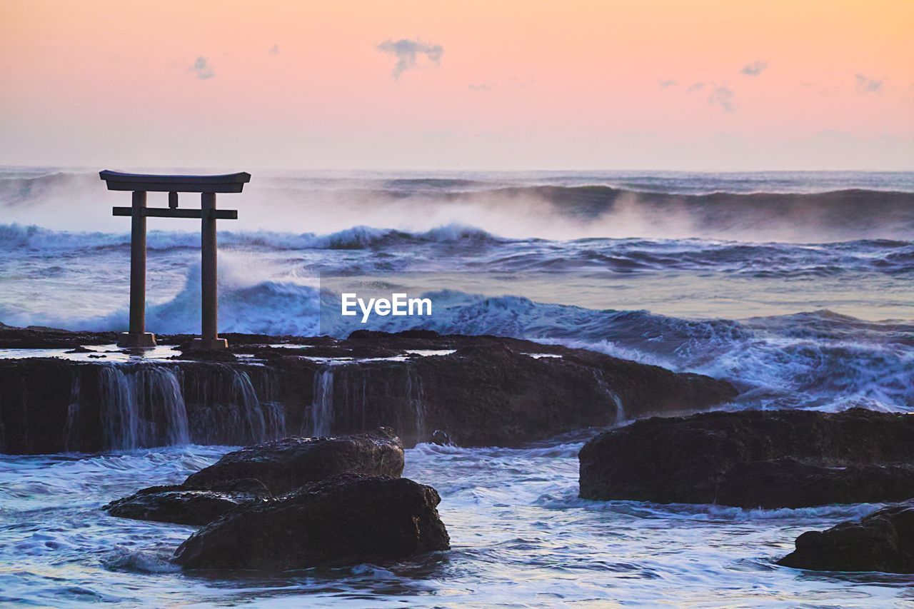 SCENIC VIEW OF BEACH AGAINST SKY DURING SUNSET