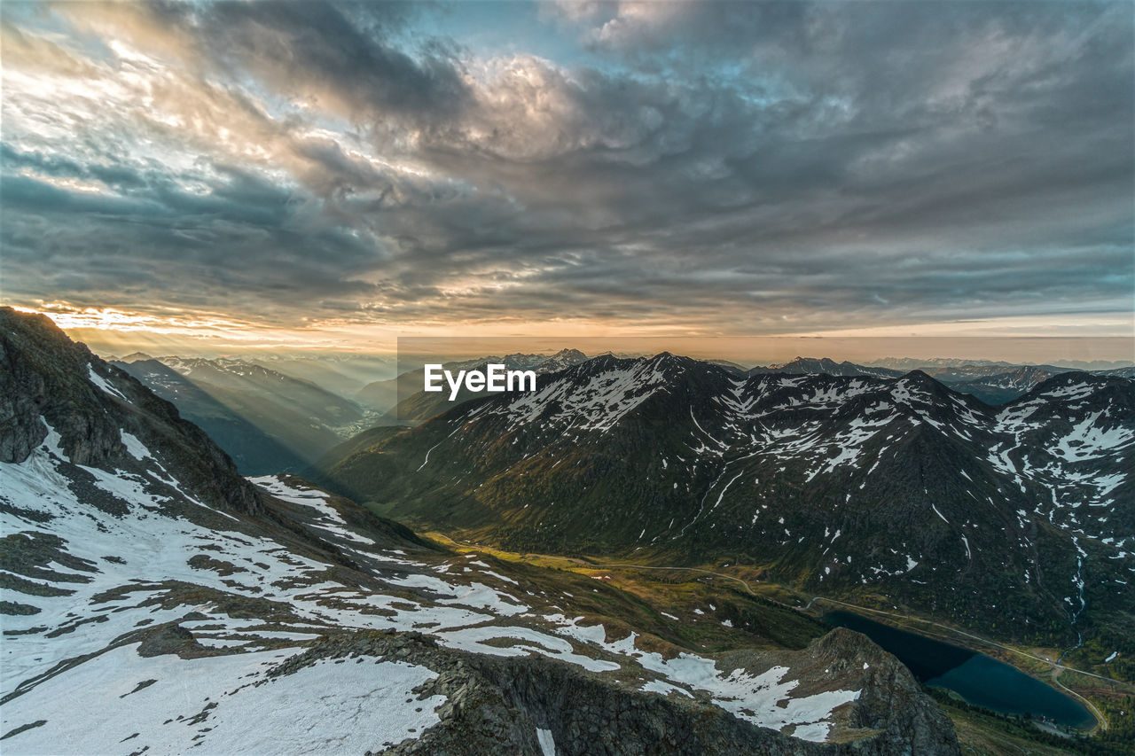 Scenic view of snowcapped mountains against sky during sunset