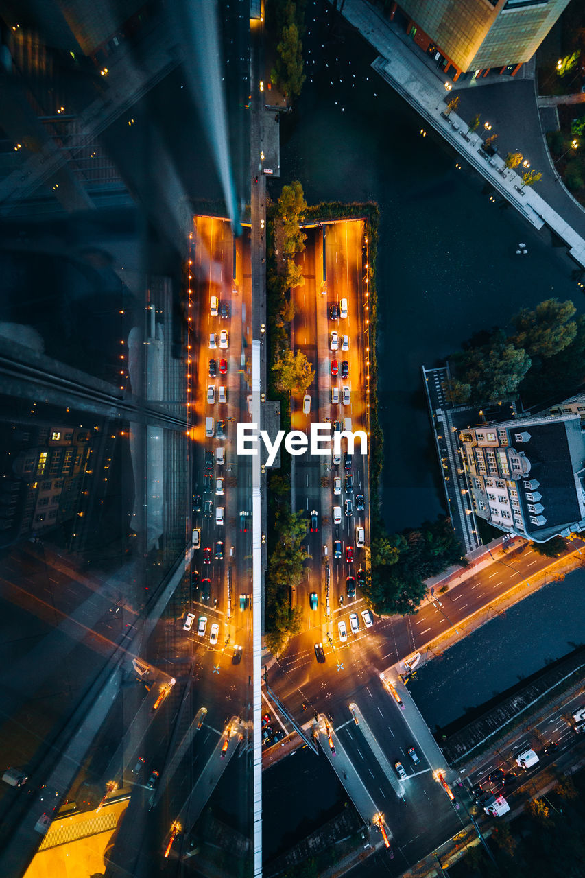 High angle view of illuminated street amidst buildings at night