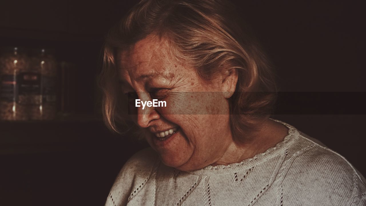 Close-up of smiling senior woman at home