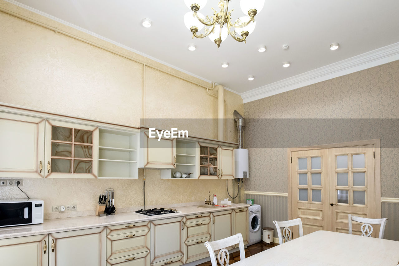 White kitchen set in the house with a large dining room.