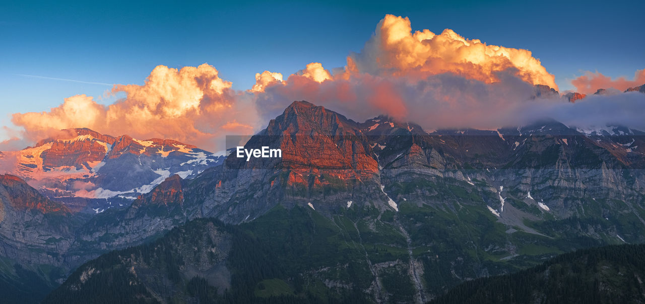 Panoramic view of snowcapped mountains against sky during sunset