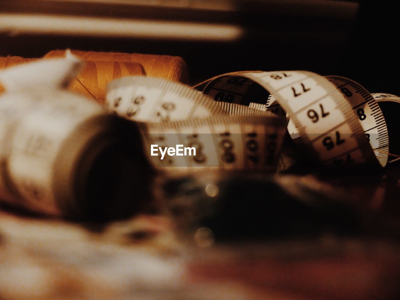 Close-up of tape measure on table in factory