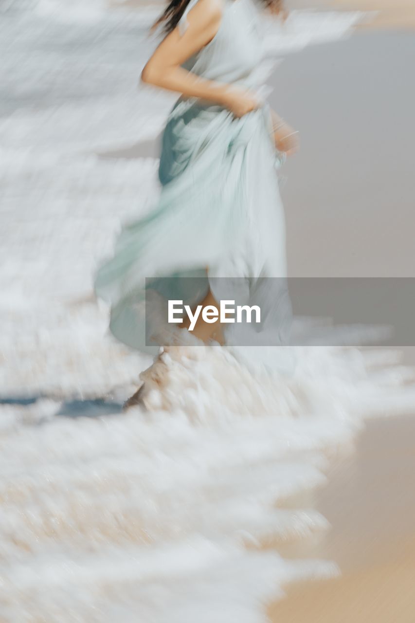 white, wedding dress, motion, one person, women, adult, dress, fashion, clothing, bridal clothing, blurred motion, young adult, full length, gown, nature, elegance, bride, water, female, dancing, wedding, hairstyle, spring, land, sea, environment, outdoors, wind, long hair, side view