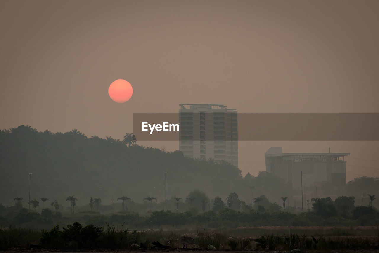 Scenic view of landscape against clear sky during sunset