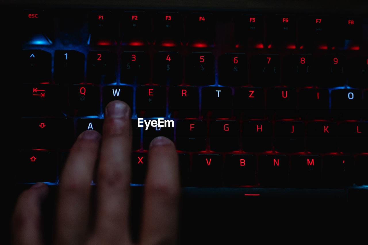 Close-up of hand typing on computer keyboard