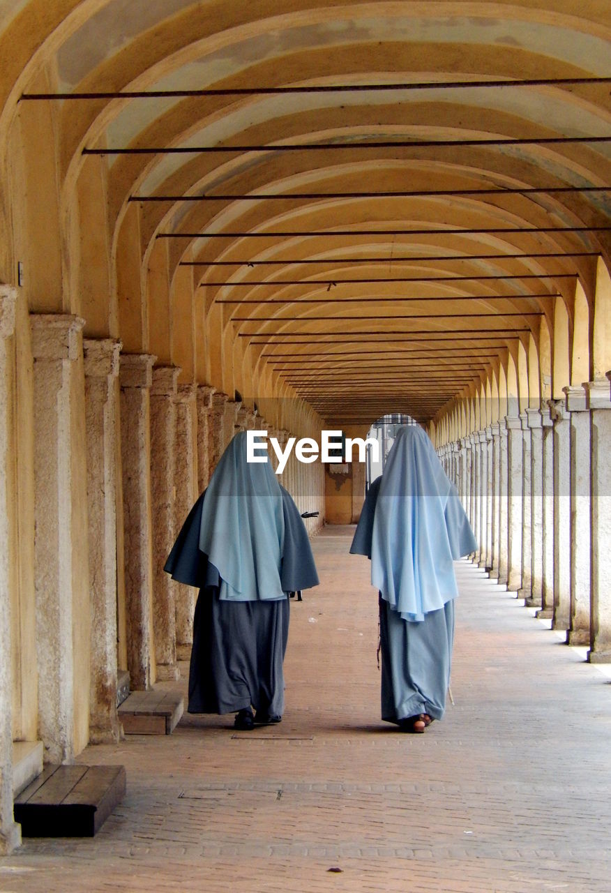 Rear view of nuns in corridor