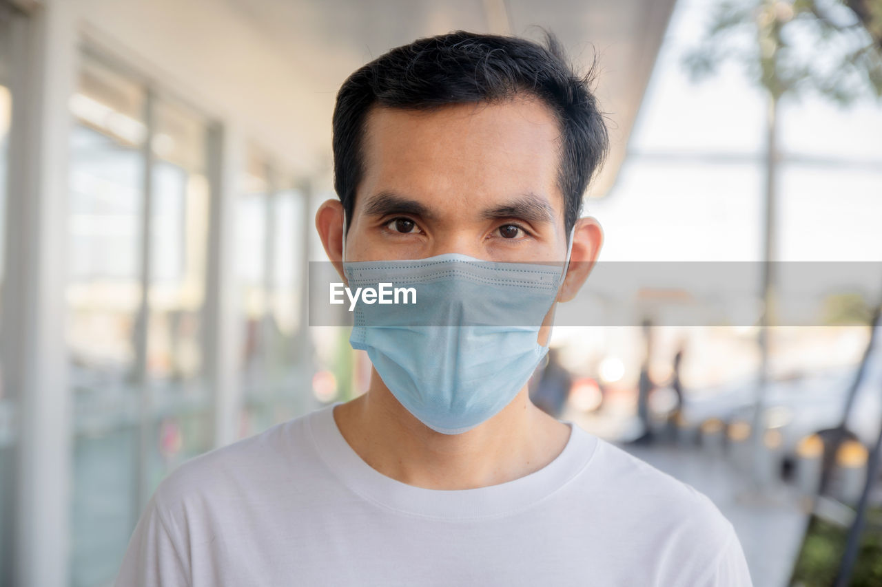 Portrait of man wearing mask standing outdoors