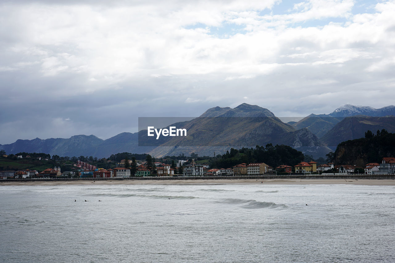 mountain, sky, sea, water, architecture, cloud, mountain range, land, city, nature, body of water, coast, environment, scenics - nature, horizon, building, shore, landscape, building exterior, travel destinations, built structure, beach, travel, beauty in nature, no people, bay, outdoors, tourism, house, day, town, holiday