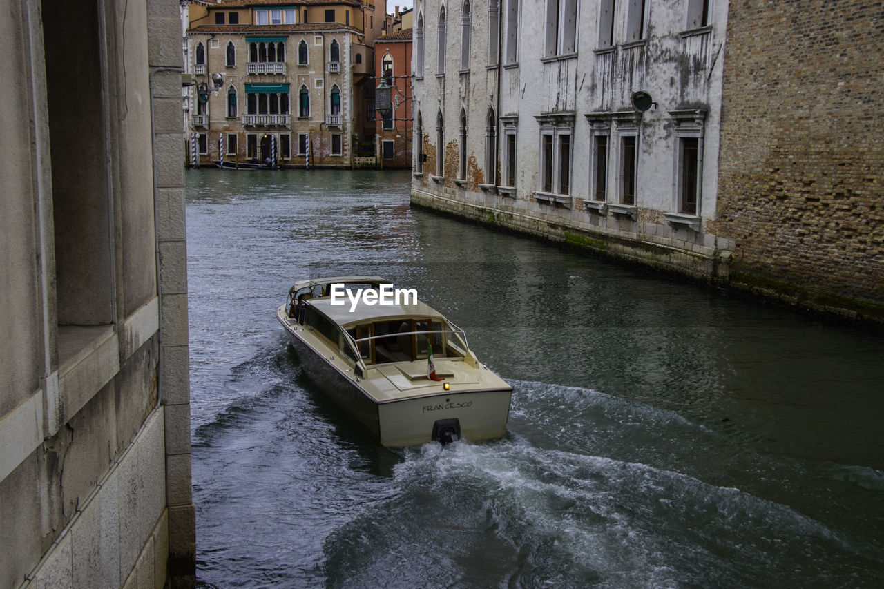 BOAT IN CANAL BY BUILDING