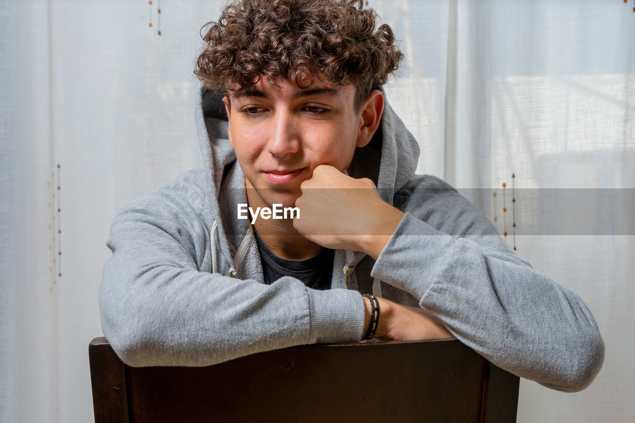 Portrait of young man sitting at home