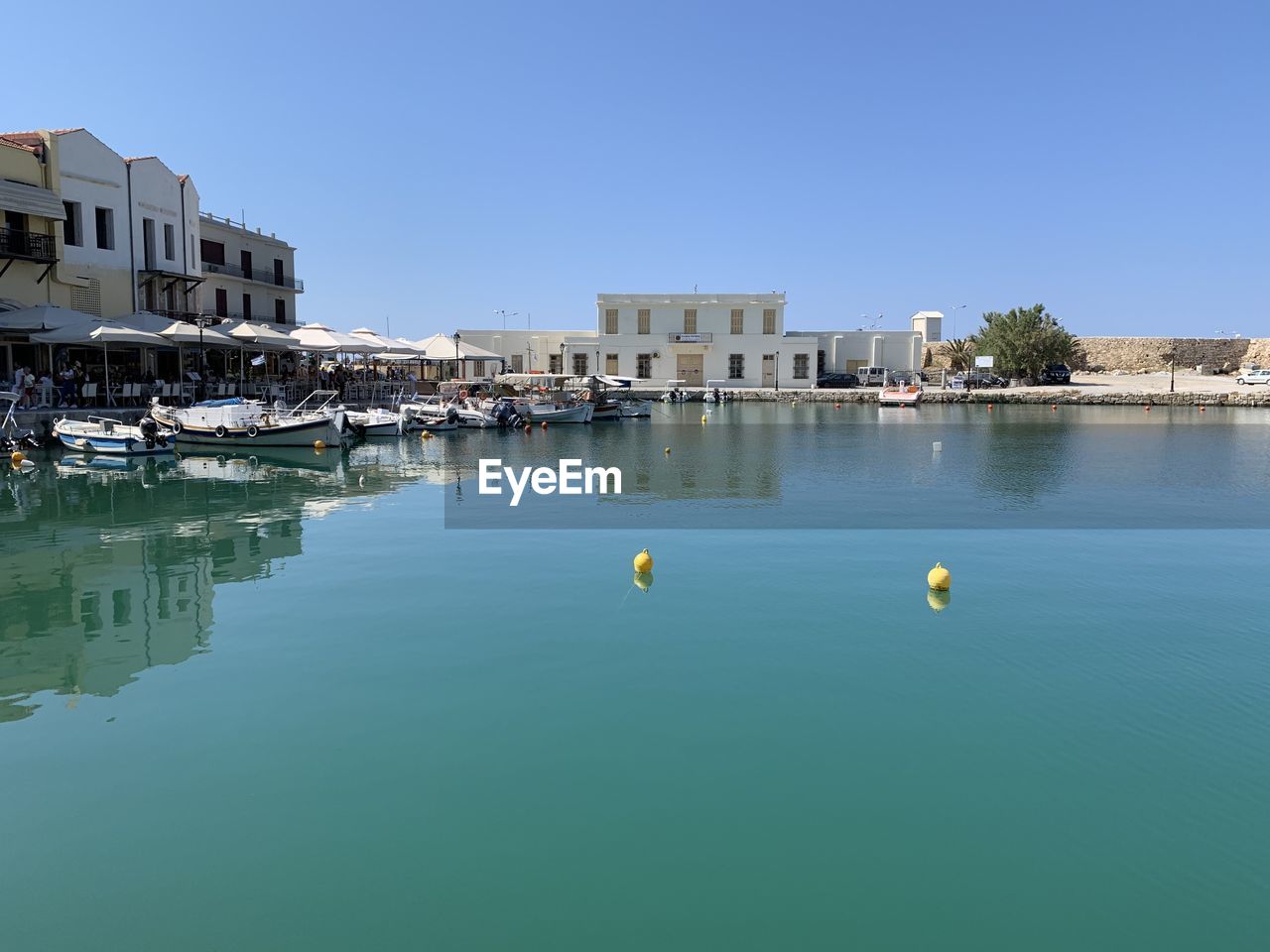 LAKE AND BUILDINGS AGAINST CLEAR BLUE SKY