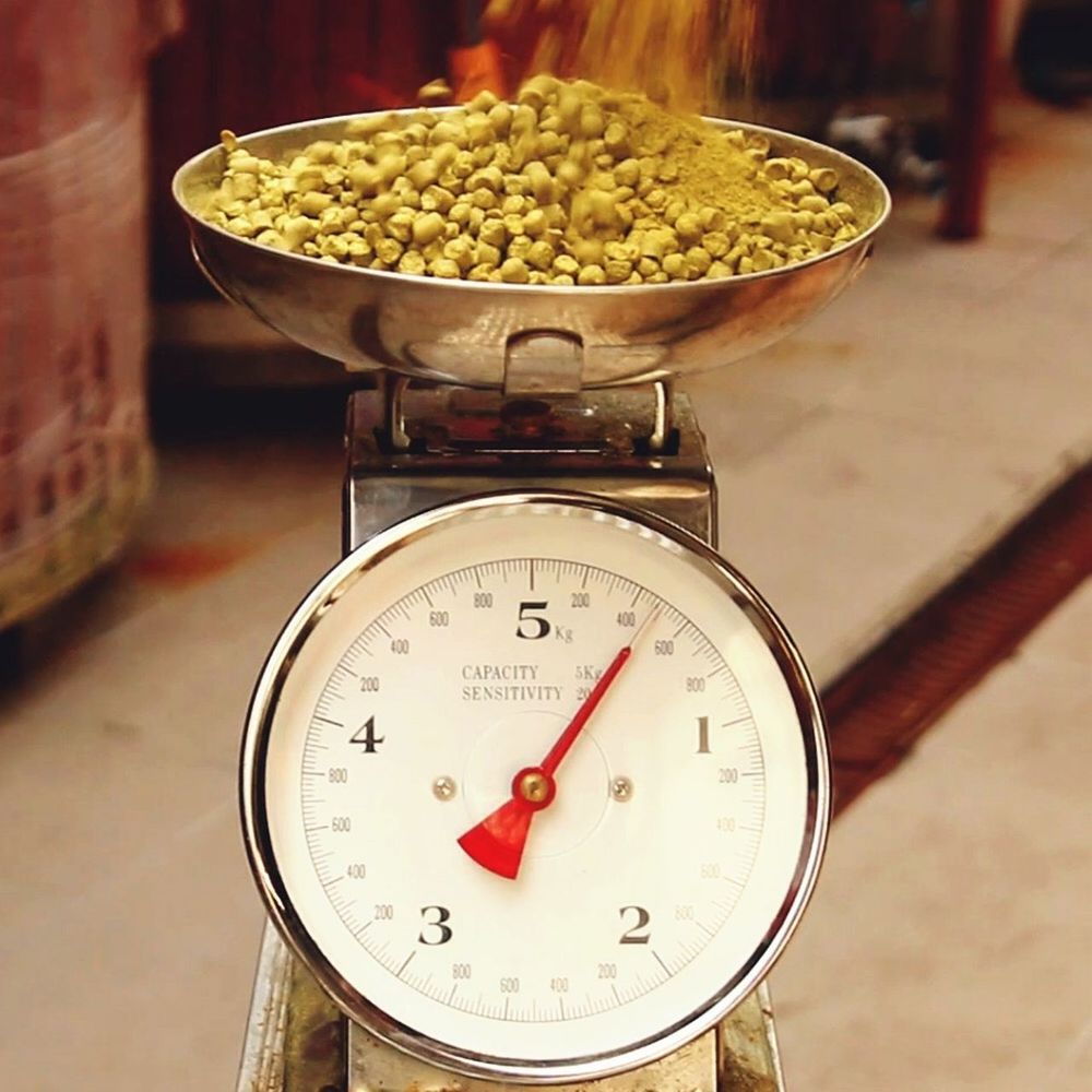 Close-up of hops on weight scale in brewery