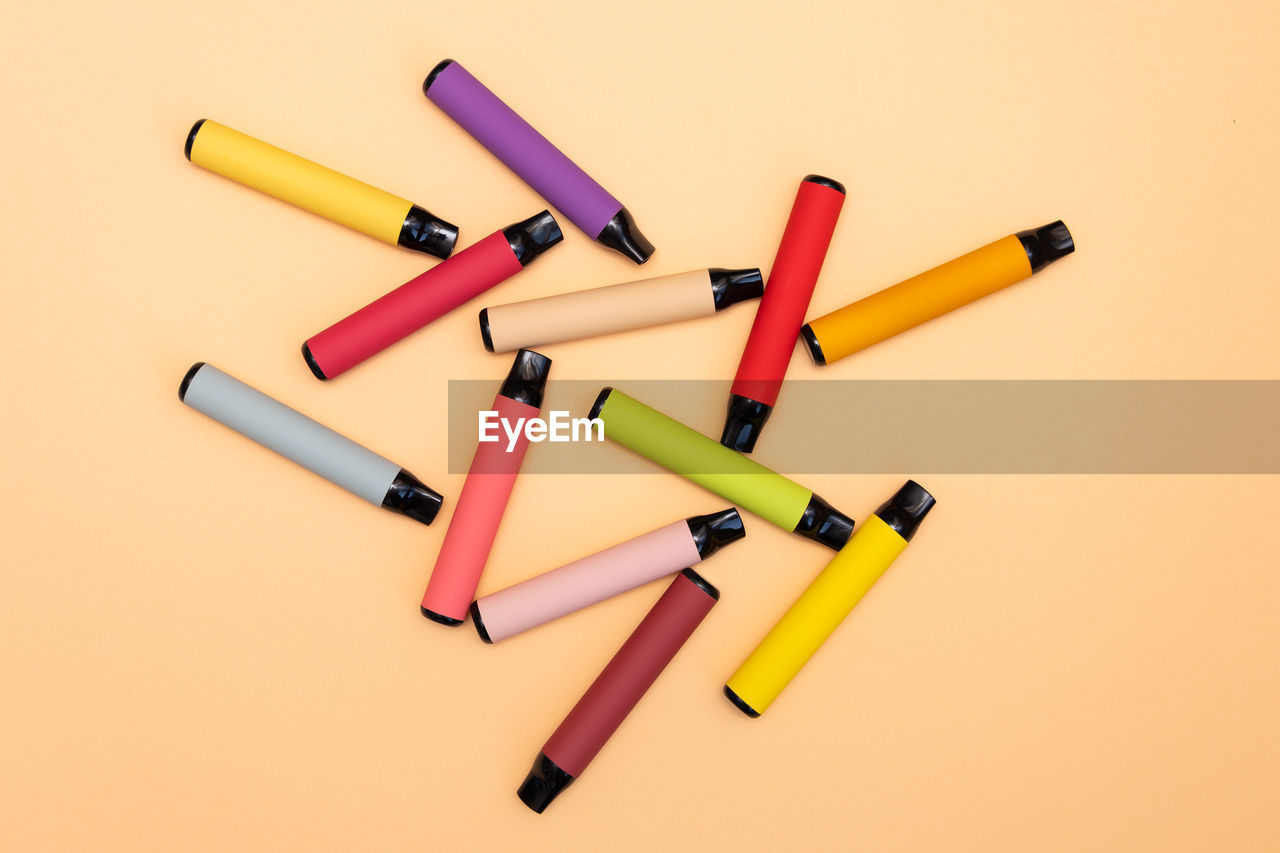 Disposable e-cigarettes, different flavors in orange. the concept of alternative smoking, vaping and