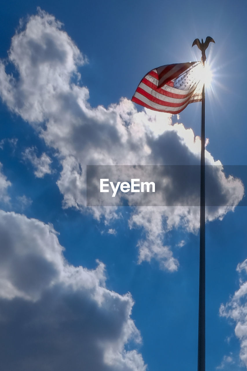 Low angle view of american flag against sky