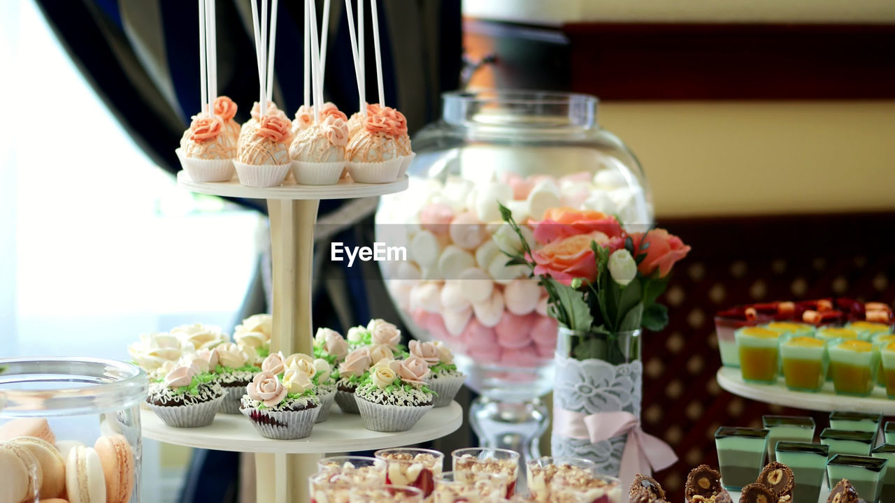 Close-up, a variety of delicious desserts, cakes with cream, strawberries, chocolate, under icing 