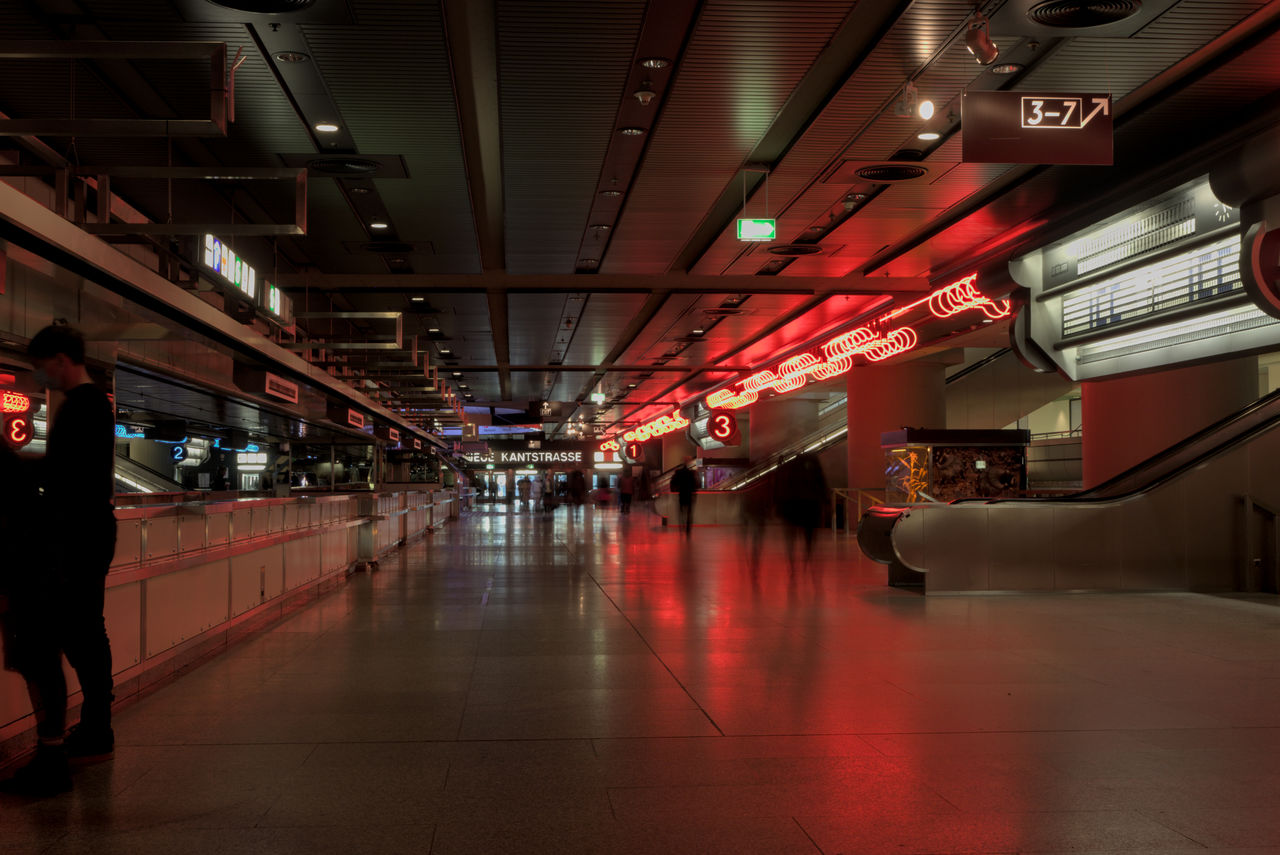 People walking in illuminated building, main hall in icc berlin