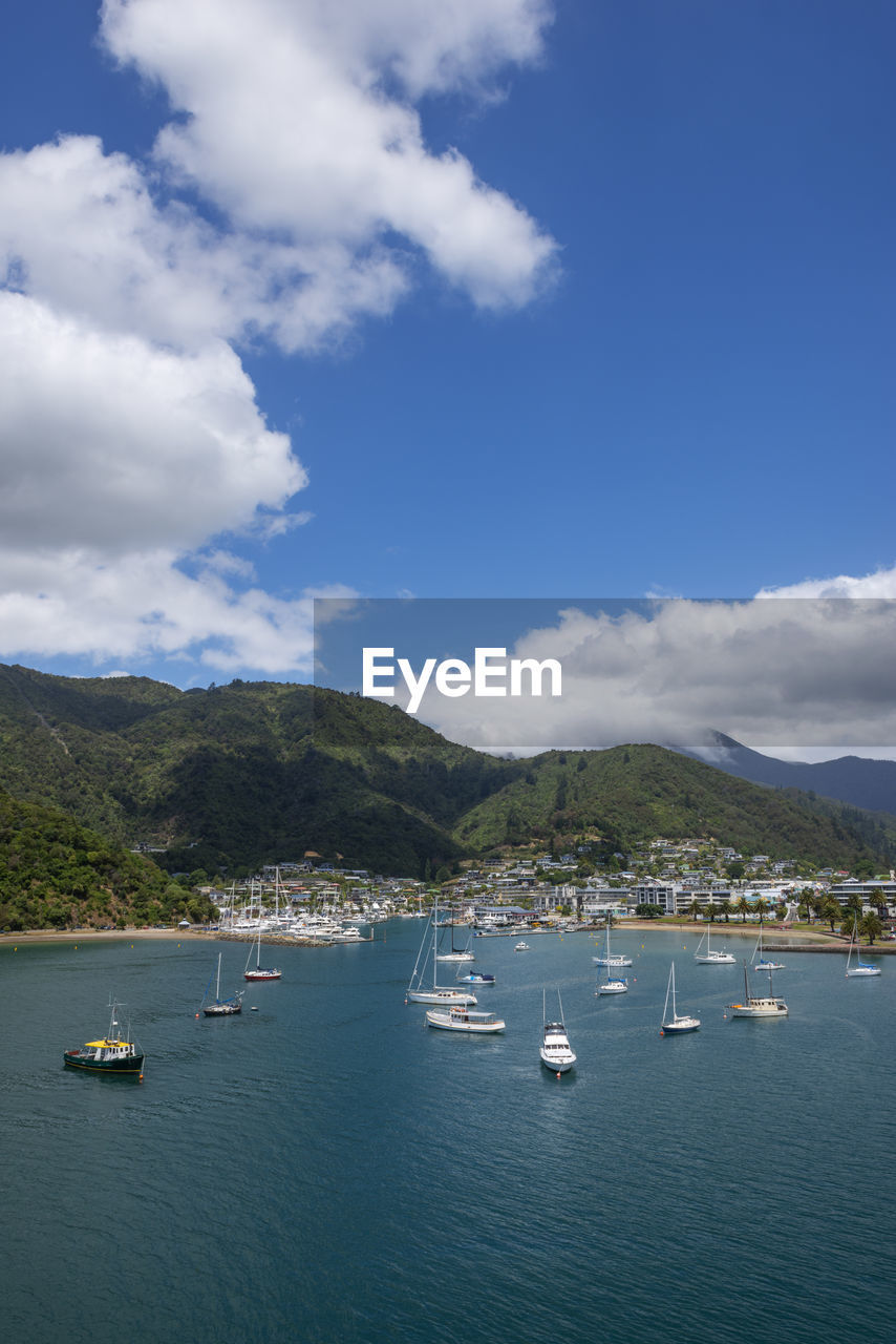 New zealand, marlborough, picton, boats in front of coastal town