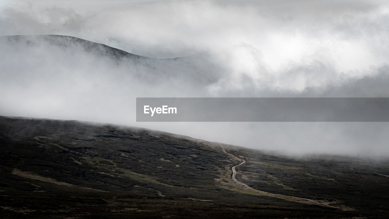 SCENIC VIEW OF LANDSCAPE AGAINST SKY DURING FOGGY WEATHER