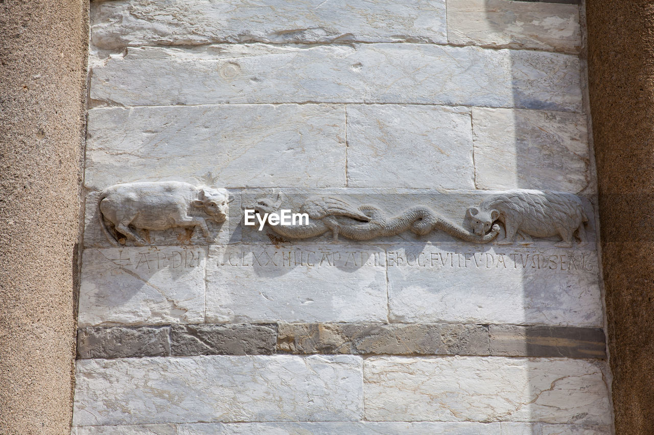 Detail of the stone carvings on the walls of the leaning tower of pisa