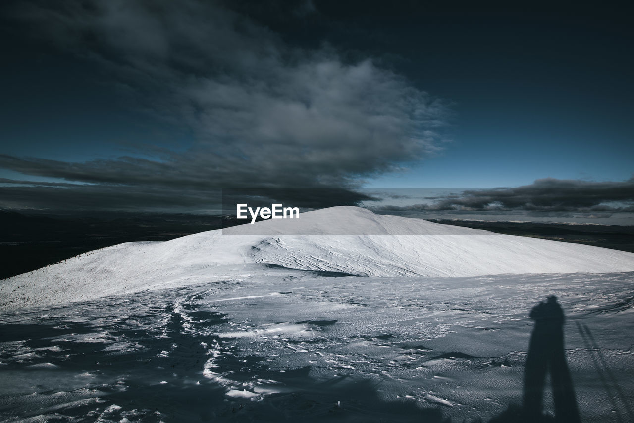 Scenic view of snow covered mountain against sky