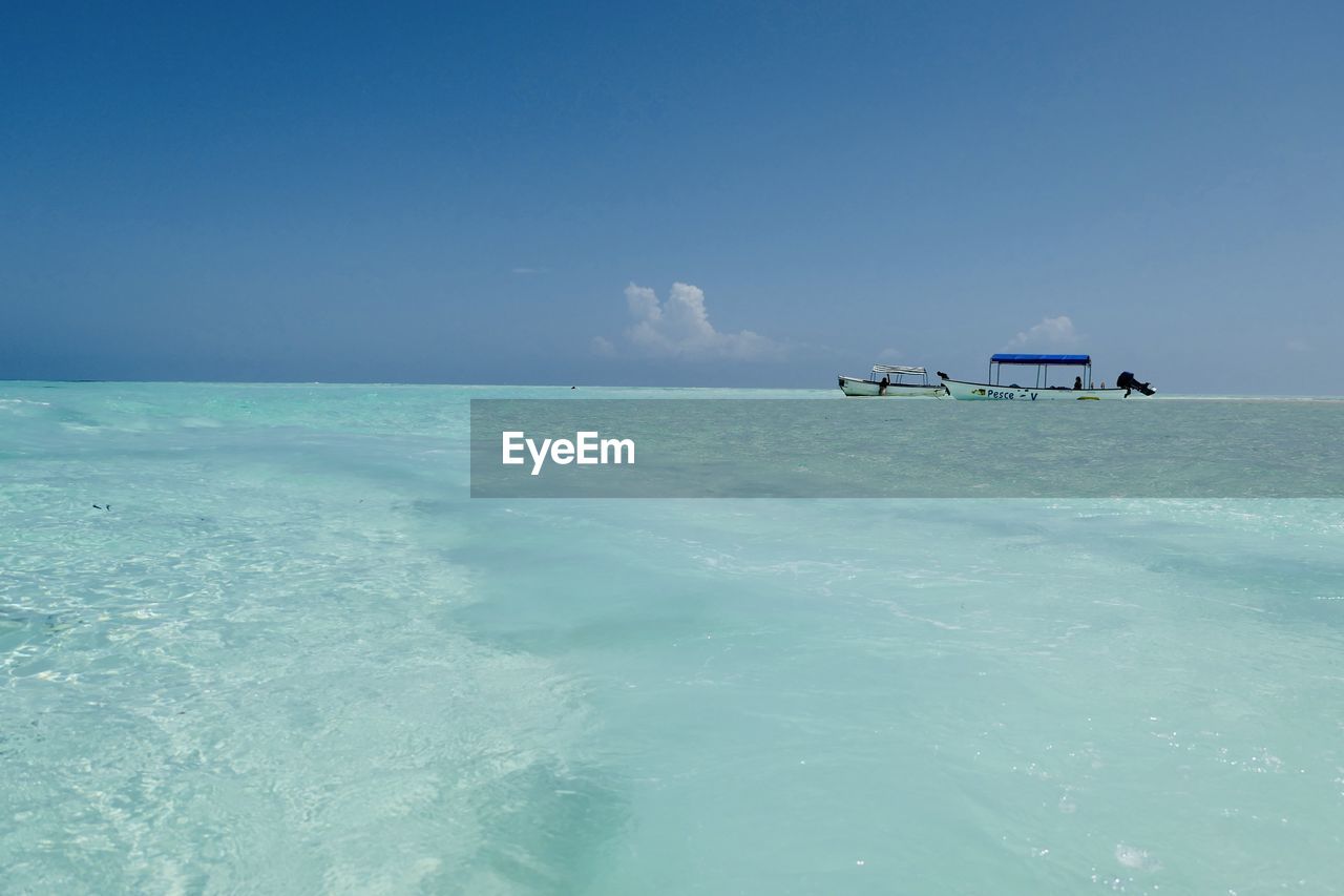Scenic view of sea against blue sky