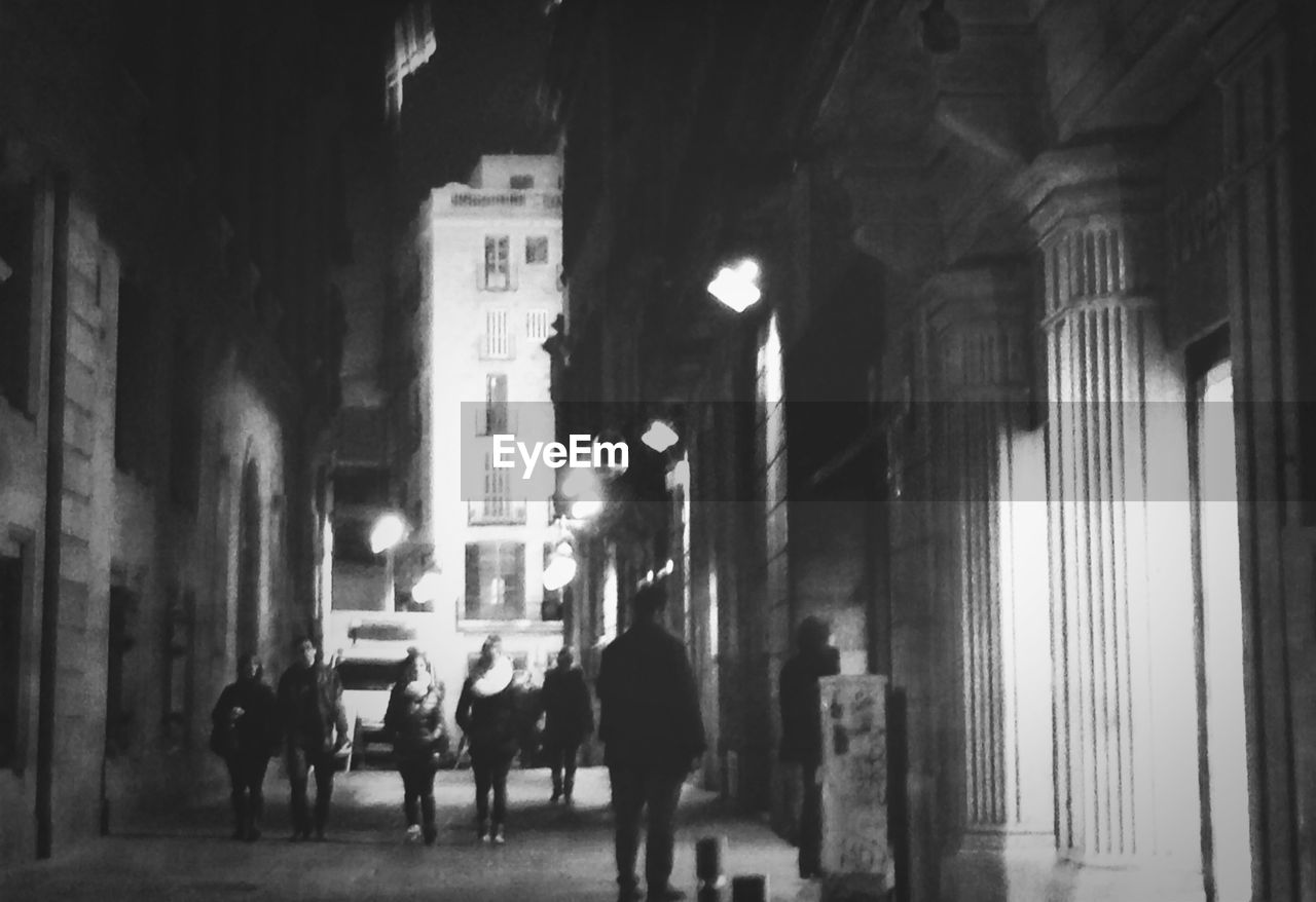 People walking along street at night