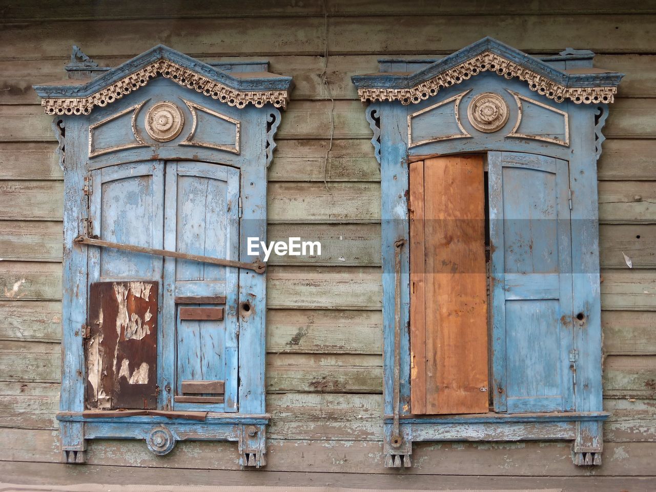Closed window shutters on an old, weathered wooden house in irkutsk, russia