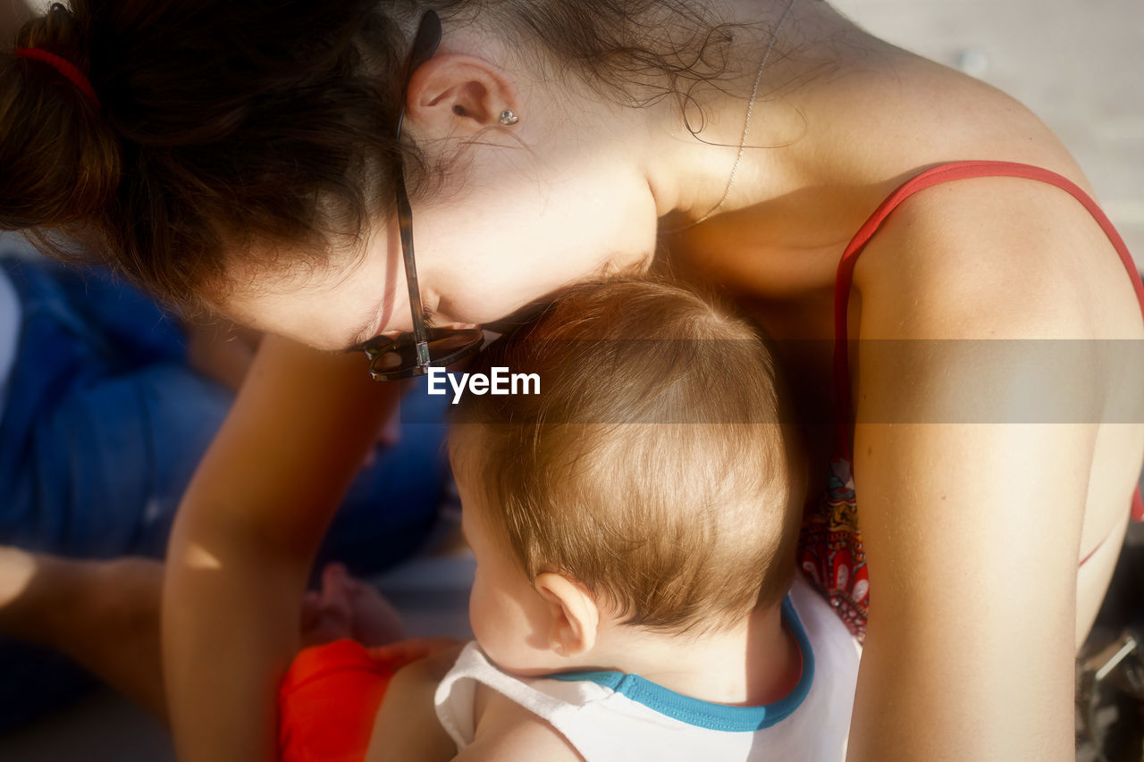 High angle view of mother with son sitting at home