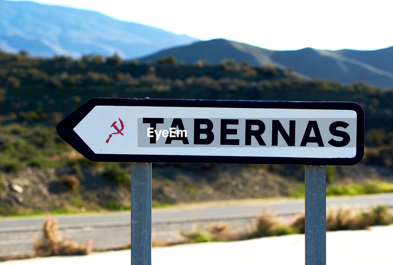 Road sign against mountains