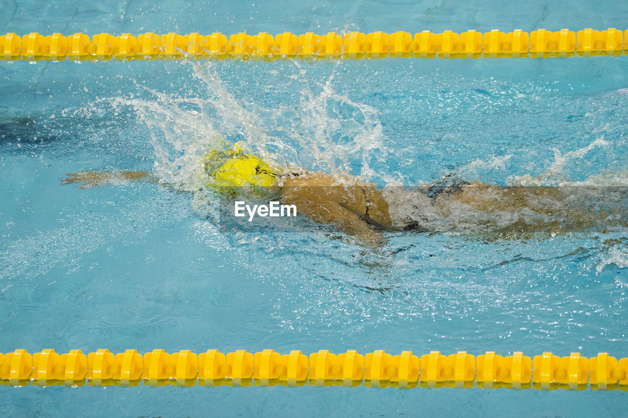 High angle view of woman swimming in pool