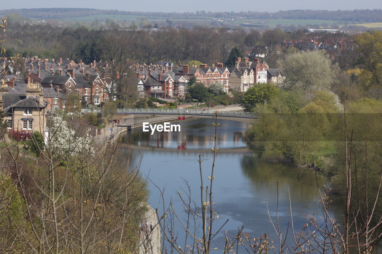 Scenic view of river by trees against sky