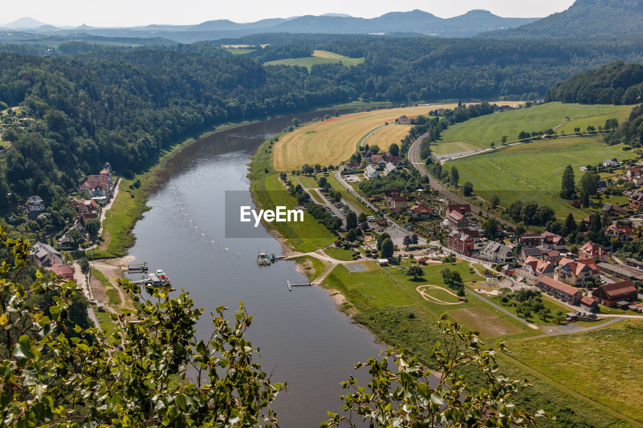 HIGH ANGLE VIEW OF RIVER AMIDST TREES AND LANDSCAPE