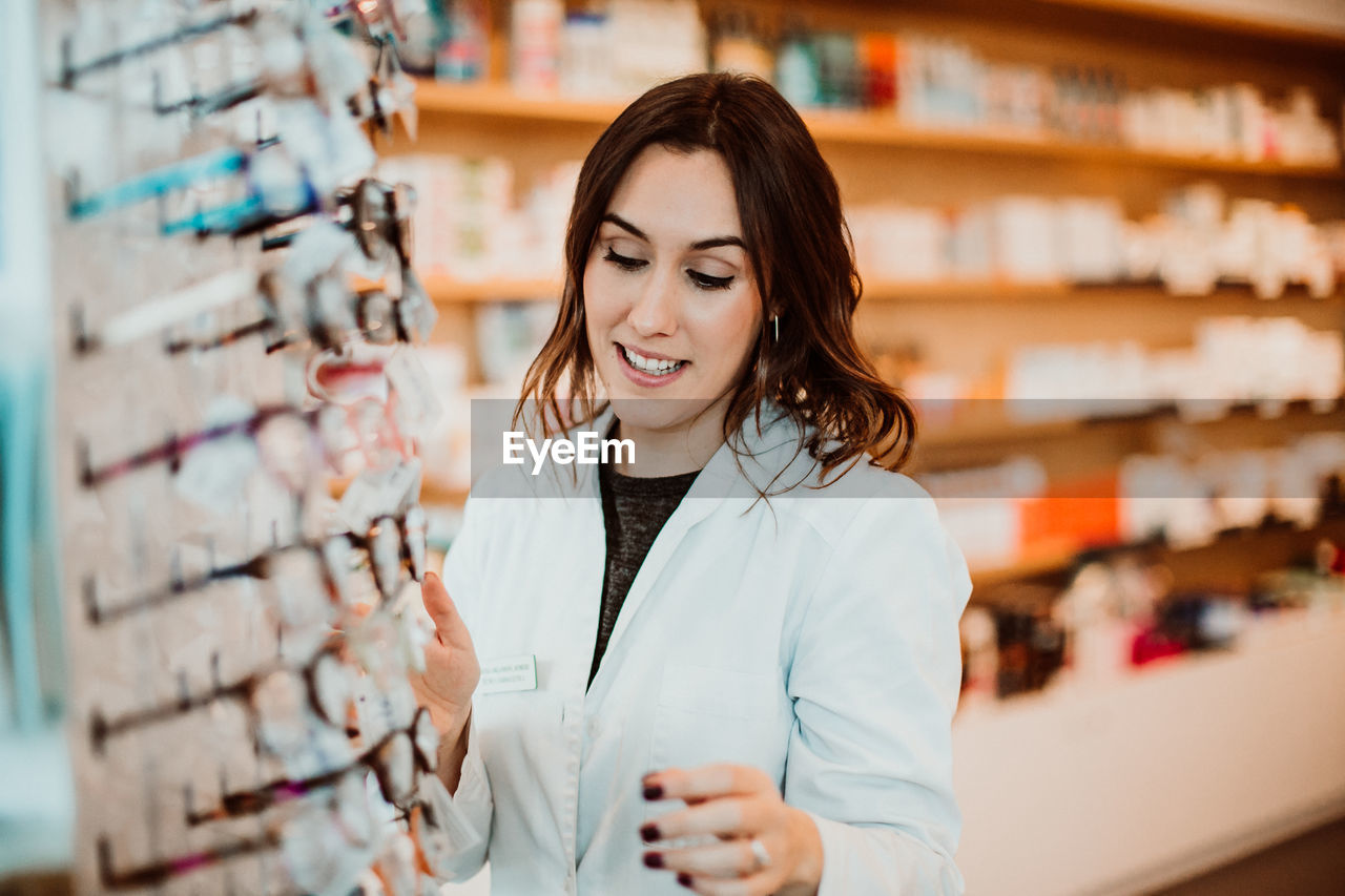 Female optometrist working at store