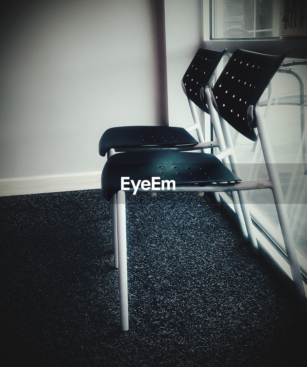 CLOSE-UP OF EMPTY CHAIRS ON TABLE