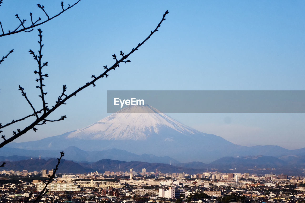 View of cityscape against clear blue sky