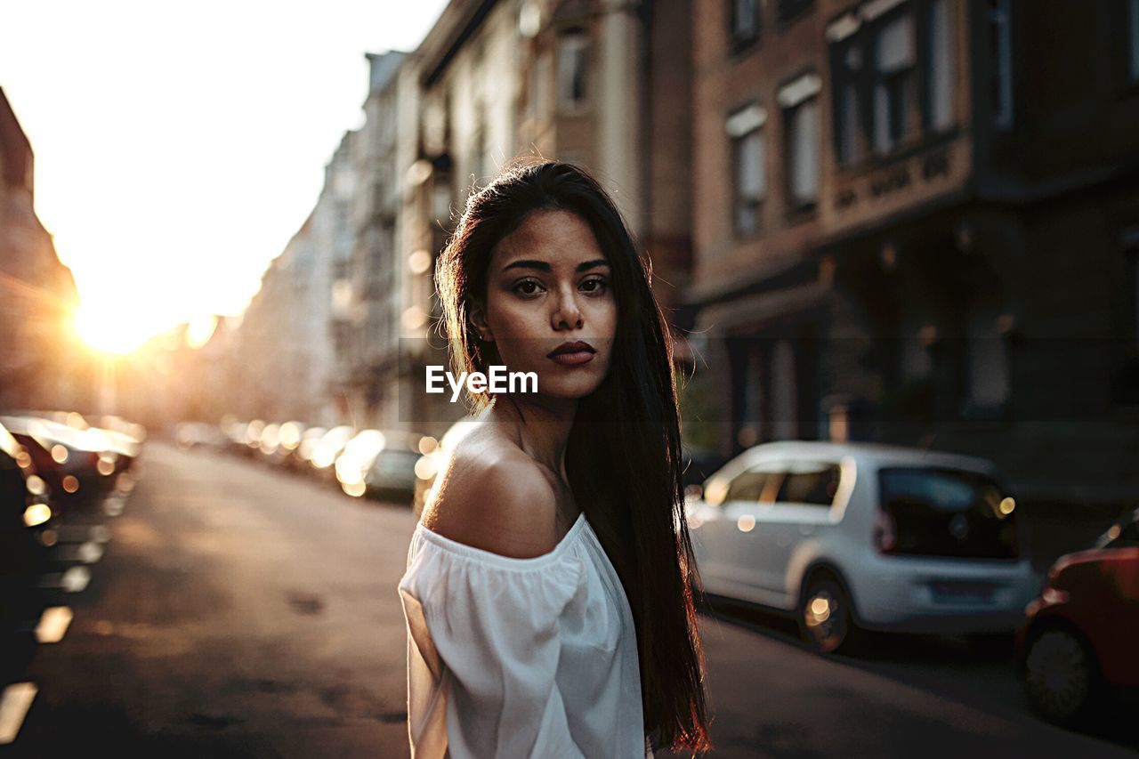 PORTRAIT OF A YOUNG MAN STANDING ON ROAD