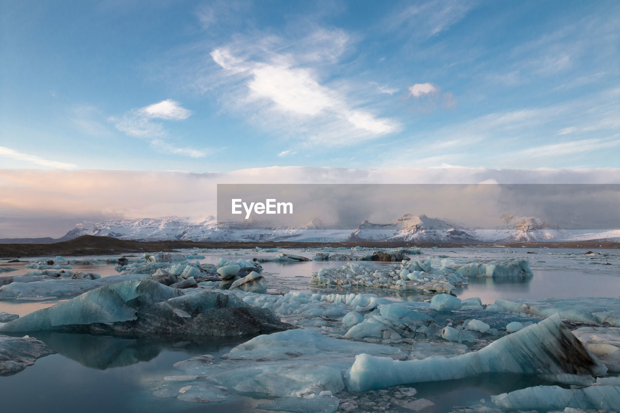 Scenic view of lake against sky during winter