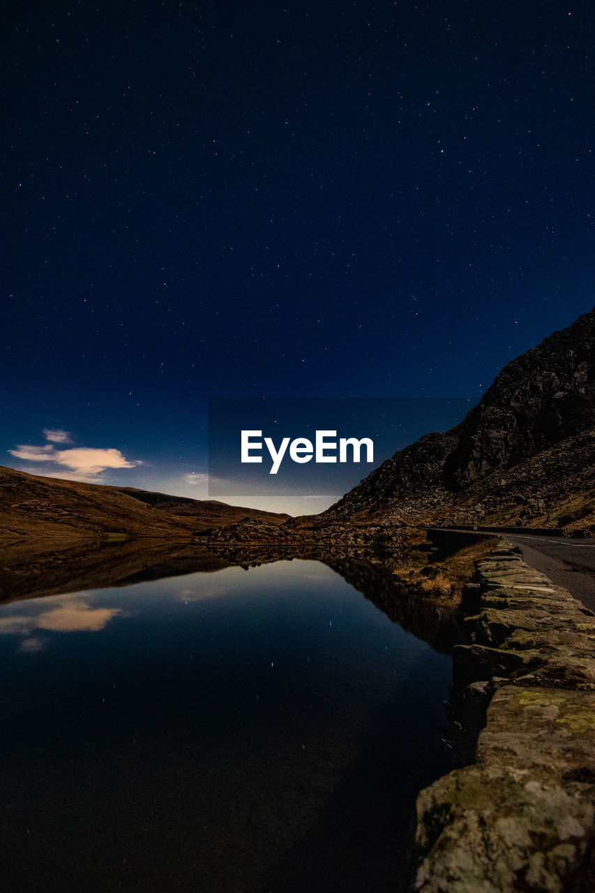 Scenic view of mountains against sky at night