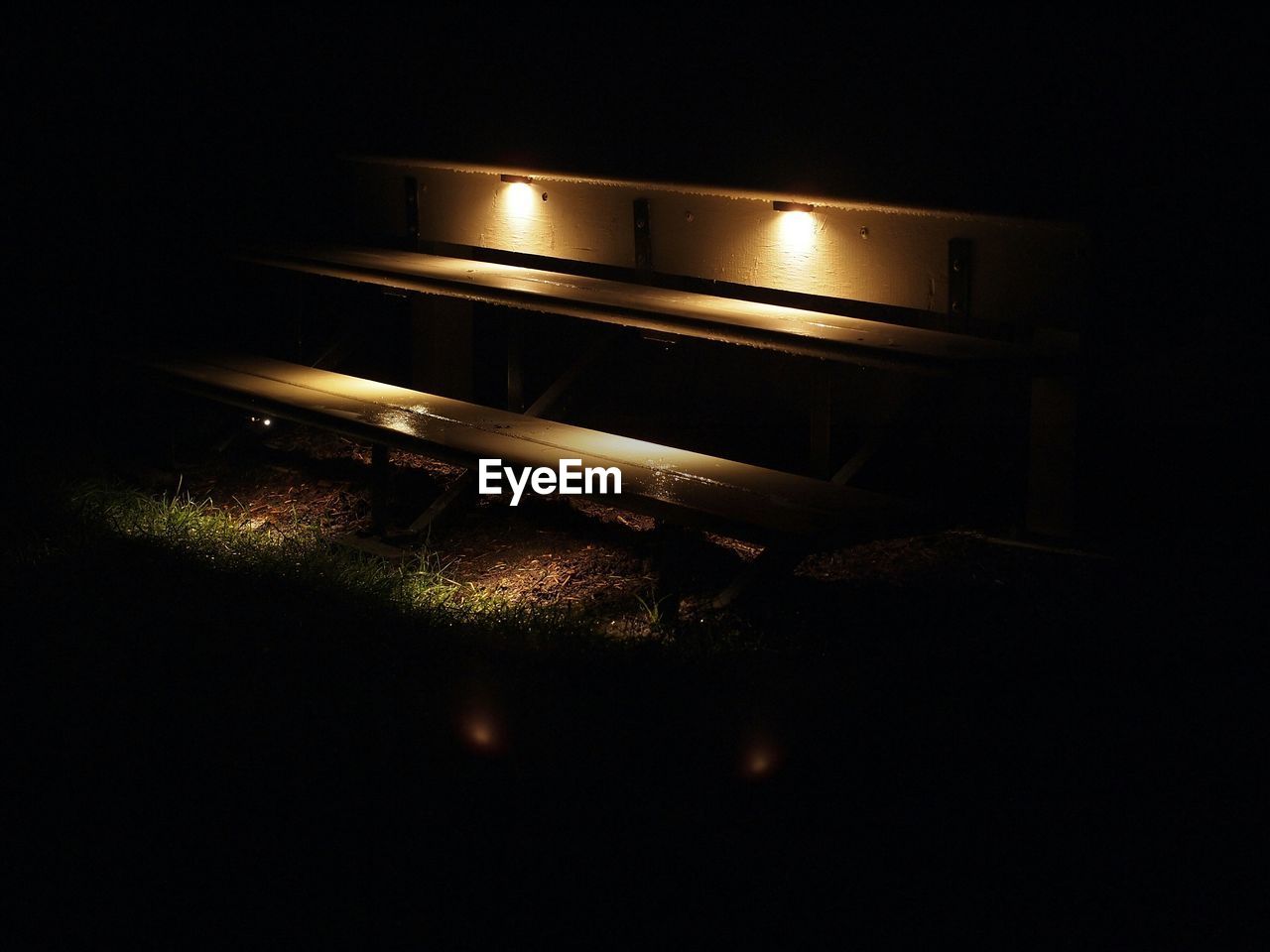 Illuminated bench at night