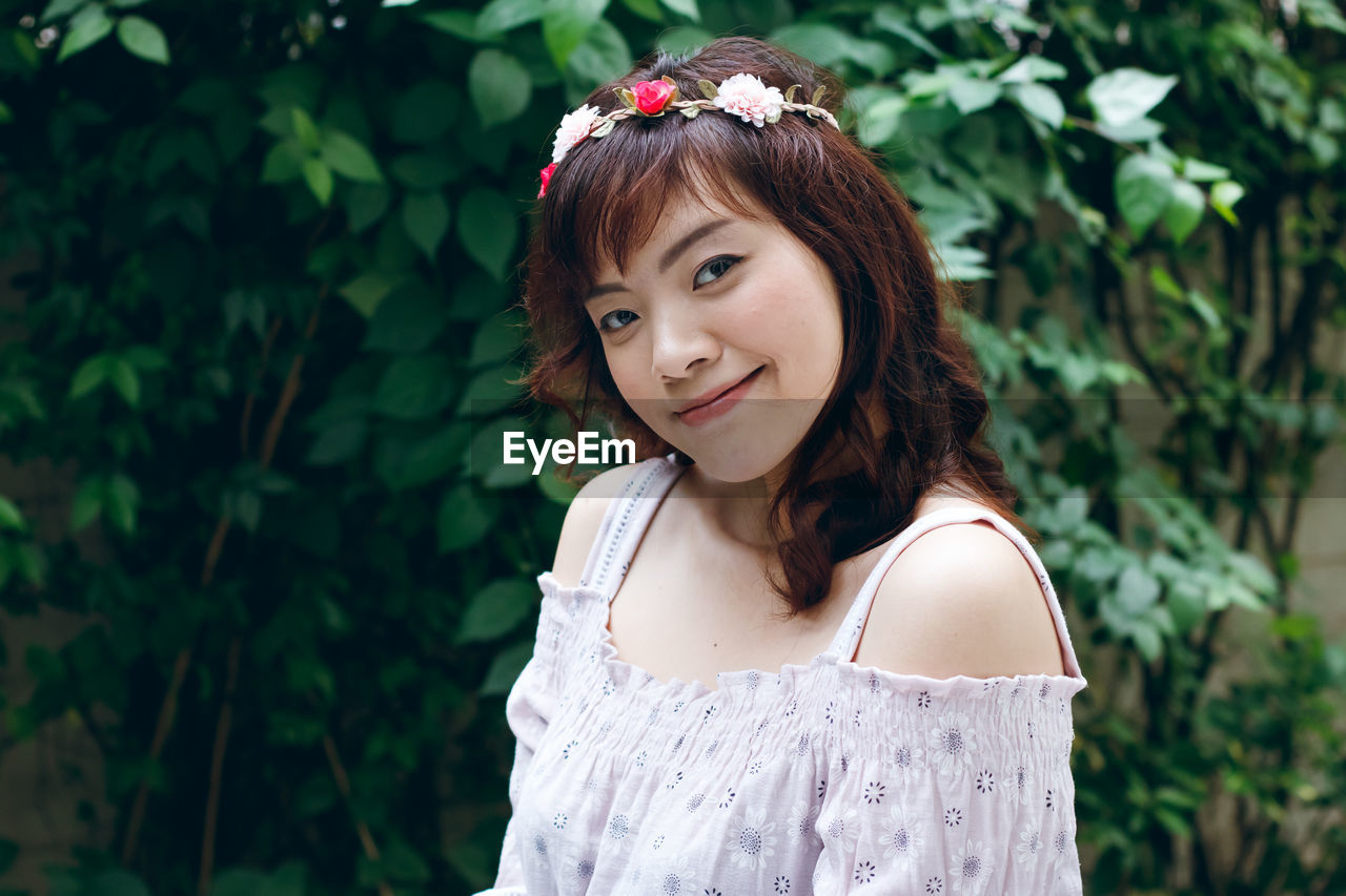 Smiling young woman standing outdoors