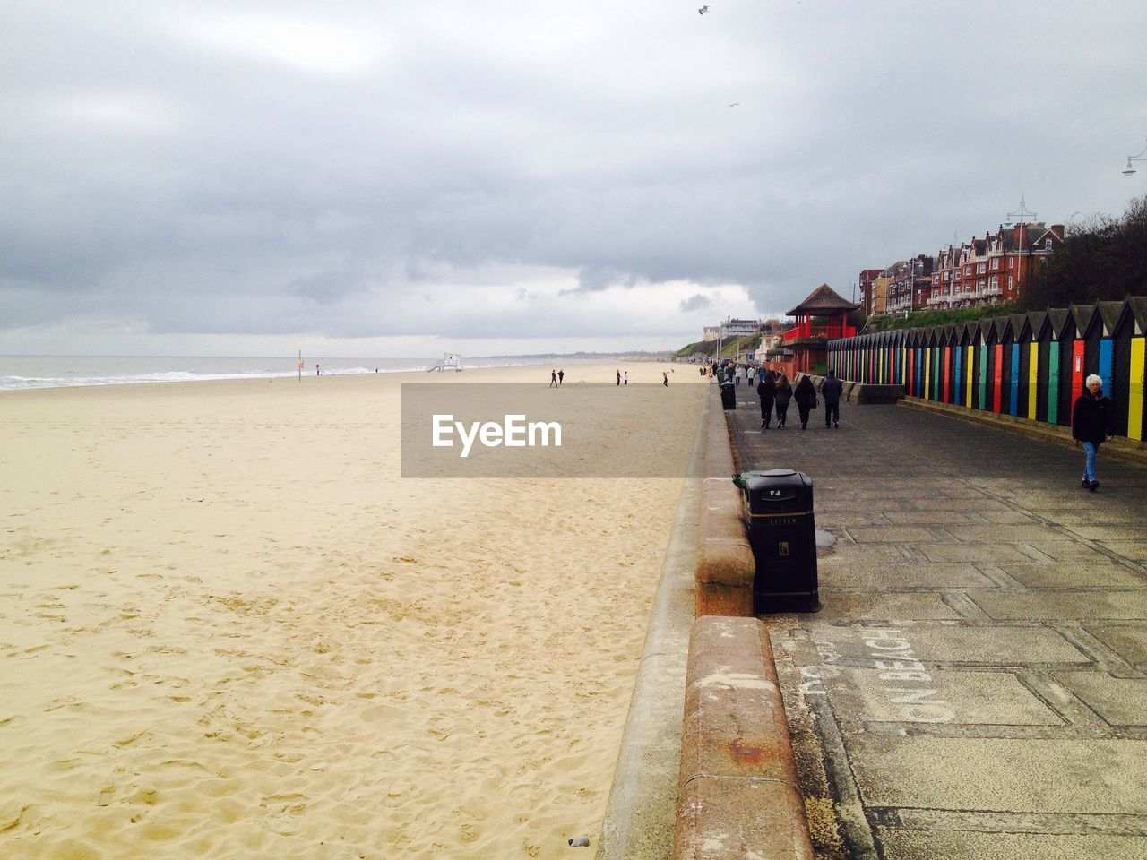 PANORAMIC VIEW OF PEOPLE ON BEACH AGAINST SKY