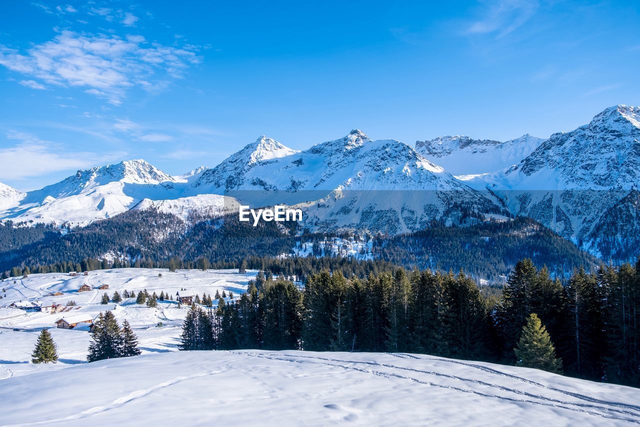 Scenic view of snow covered mountains against sky