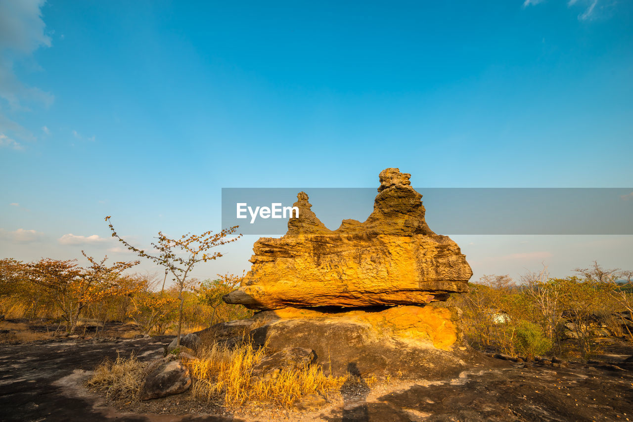 ROCK FORMATION ON LAND AGAINST SKY