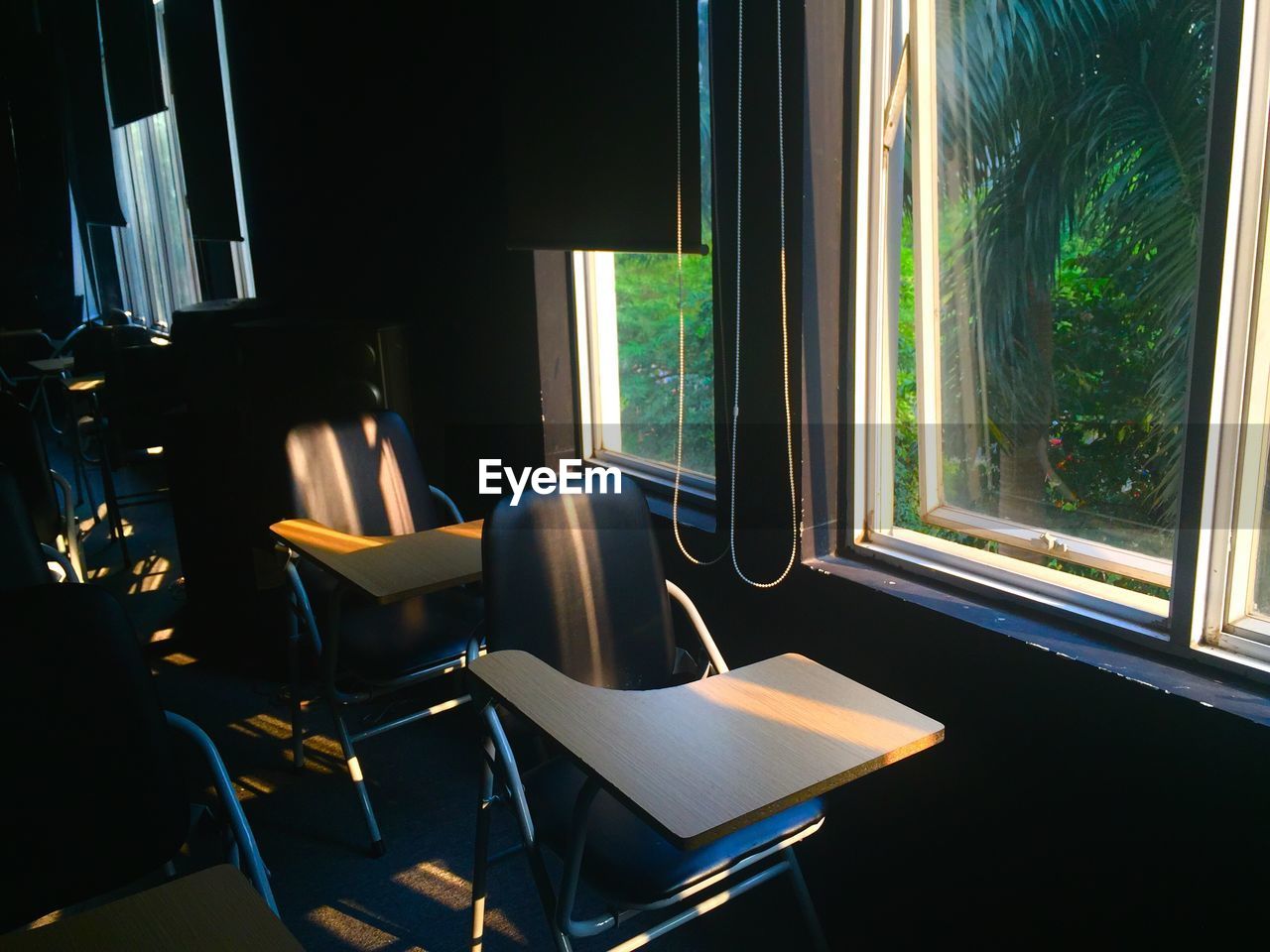 Empty chairs and table by window at home