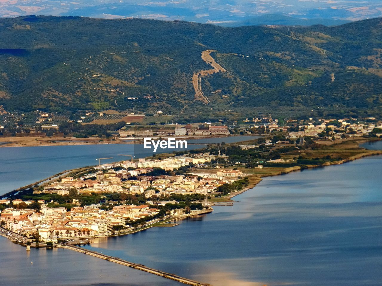 Townscape by sea against mountain